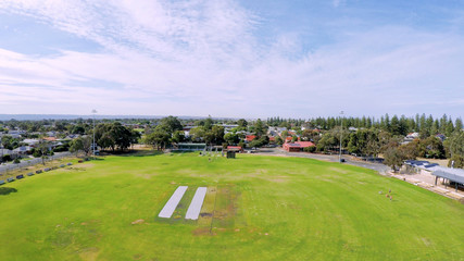 Drone aerial view of Australian public park and sports oval field, taken at Henley Beach.