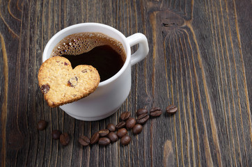Coffee and cookie in the shape of a heart