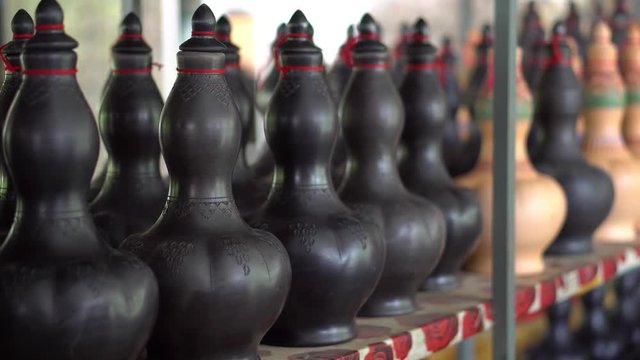 Handmade traditional craft known as 'labu sayong' normally used as gift or souvenir found in Perak,Malaysia. Clay pottery arts. Artistic clay container carving. UNGRADED.Panning Shot