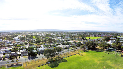 Drone aerial view of Australian public park and sports oval field, taken at Henley Beach.