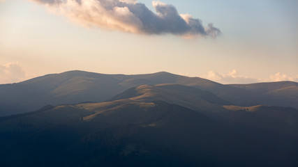 Beautiful sunset rays falling on top of a valley in Buila Vanturarita mountains, Romania