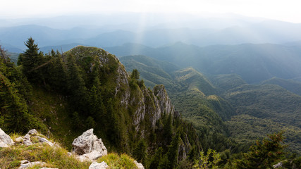 Beautiful sunset rays falling on top of a valley in Buila Vanturarita mountains, Romania