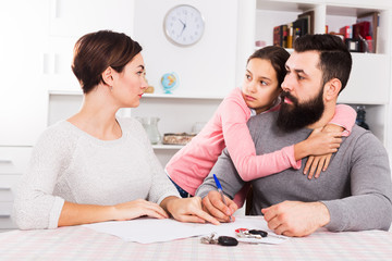Parents signing papers for divorce