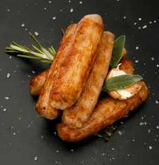 Grilled seasoned tastey sausages with a garlic and herb garnish