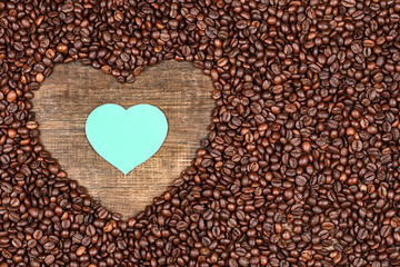 Heart of coffee beans on a wooden surface