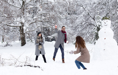 Friends having snowball fight