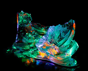 Colorful ice pieces painted by light create a festive mood