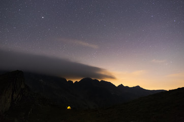 Stars rising above a tent in the mountains of Romania
