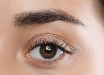 Obraz premium Young woman with beautiful eyelashes, closeup view