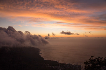 clouds over table mountain in south africa above cape town during sunset