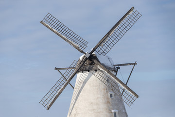 Grain mill on the winter landscape. Dutch windmill and natural background pattern