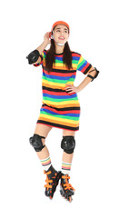 Full length portrait of young woman in bright dress with roller skates on white background