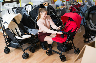buyer choosing stroller cane in the shop