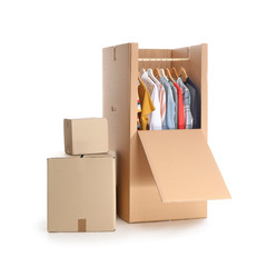Cardboard wardrobe box with clothes on white background