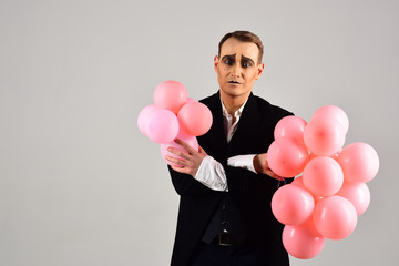 Special day to celebrate. Mime man with party balloons. Balloon artist. Man with mime makeup on...