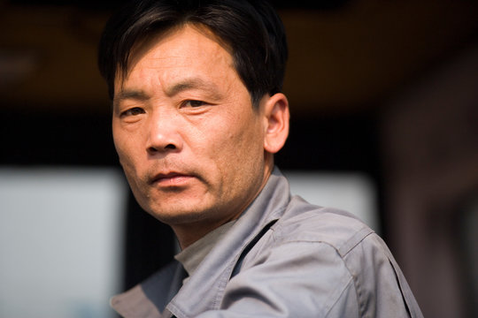 Portrait of a mid-adult male construction worker at a shipping yard.