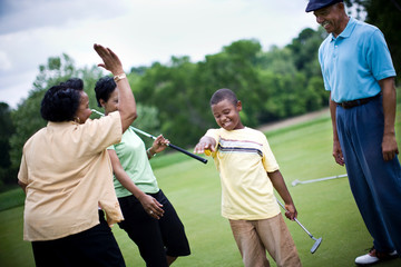 Family playing golf together