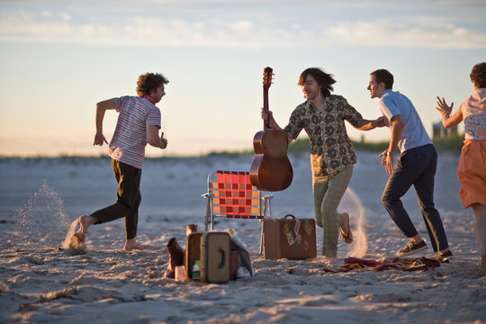 Group of young adults having fun together at the beach.