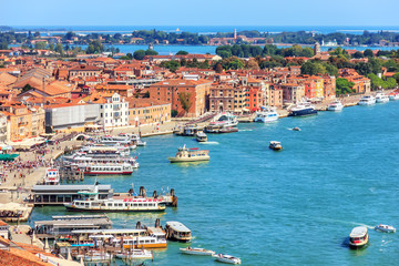 Naklejka premium Venetian lagoon and a berth for gondolas and boats, Venice, Ital