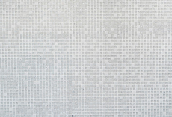 White mosaic tile pattern on the wall.