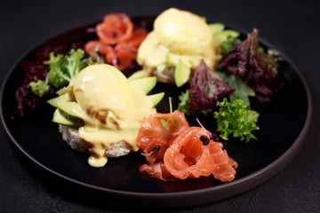 poached egg on wholemeal bread toast and smoked salmon with green salad, healthy breakfast and diet food