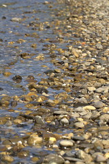 Round pebbles on the sea close up