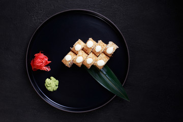 Japanese restaurant menu photo, seafood, national cuisine. Delicious sushi. Appetizing rolls served on black plate, flat lay