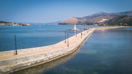 Fototapeta na wymiar The obelisk and the de Bosset bridge on lakeside in Argostoli, Kefalonia, Greece