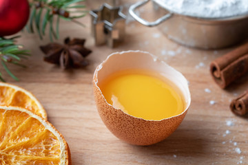 Fresh egg yolk and other ingredients for Christmas baking