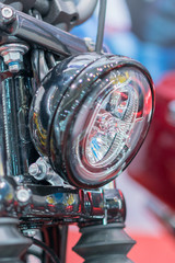 Close-up on chrome headlights of luxury Motorcycle. Chromed headlamp of a motorcycle, stylish...