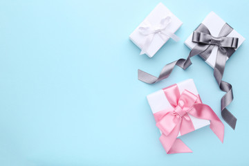 Colorful gift boxes with ribbon on blue background