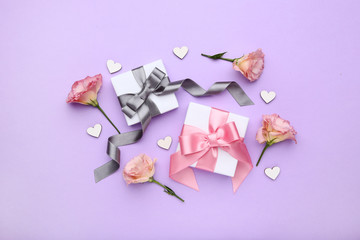 Gift boxes with eustoma flowers on purple background