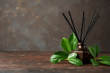 Aroma reed diffuser, home fragrance bottle with rattan sticks with leaves and smell of freshness...