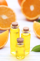 Orange oil in bottles on wooden table