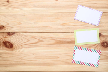 Handmade colorful greeting cards on brown wooden table