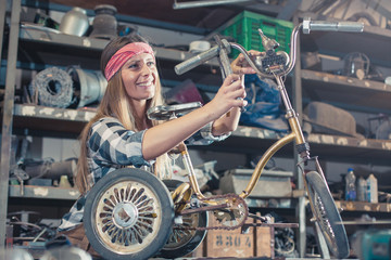 woman repairing children's bicycle