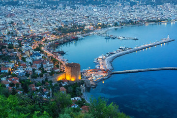 Magnificent evening top view of the bay of the Mediterranean Sea and cityscape with the old historic tower, Alanya, Turkey