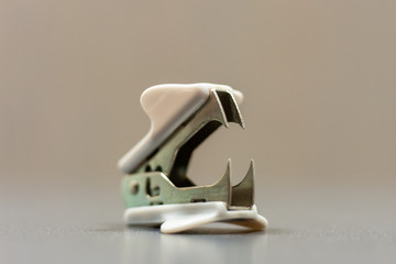 Paper clip remover at office desktop. Selective focus.