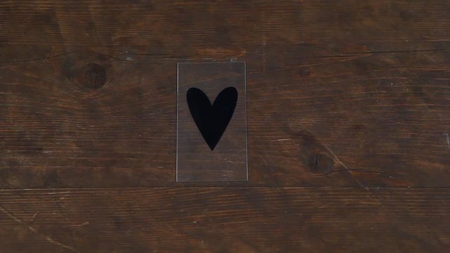 wooden table paper roll black heart symbol hd footage 
