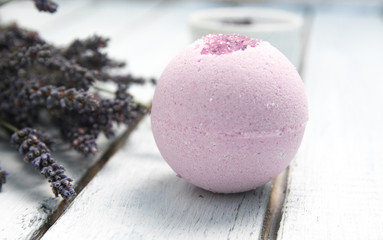 Natural cosmetics. Handmade lavender bath bombs and lavender flowers on white wooden planks