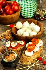 Fototapeta na wymiar Traditional Italian Mozzarella cheese on a wooden board. Healthy cheese. Dairy products. Mozzarella cheese balls with tomatoes. Diet food.