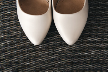 Womens wedding shoes on dark background, the fees of the bride, selective focus