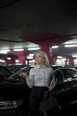 Fototapeta na wymiar Portrait of a saleswoman working at a car dealership .