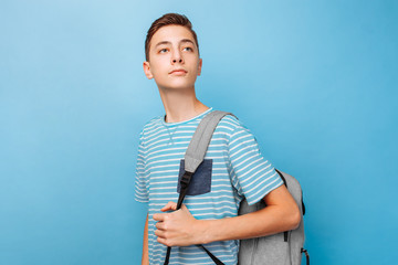 Cute teenager with a briefcase, on a blue background