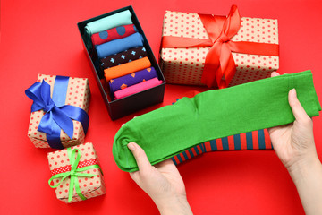 Colorful collection of cotton socks as a gift in woman hands.