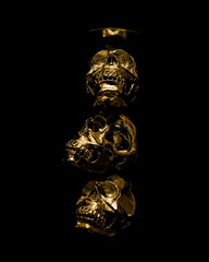 Golden Skulls - 3 skull gold with dark background