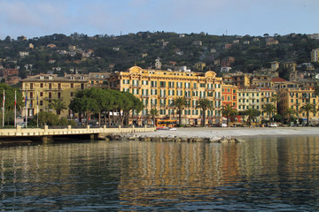 Fototapeta premium Santa Margherita Ligure, Italy 04-12-2011 Waterfront buildings of Santa Margherita reflected in the calm waters of the harbor on the Italian Riviera.