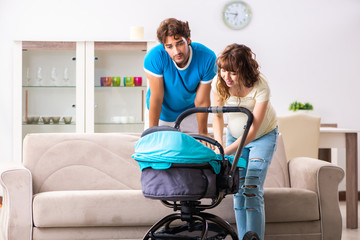 Young parents with baby expecting new arrival