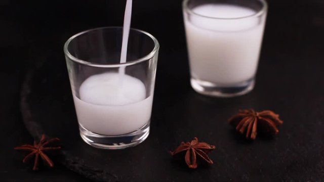 Arabic alcohol drink Raki with anis on slate black background. Turkish and Greek Traditional aperitif arak