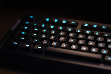 Keyboard with blue backlight on work table, button lights